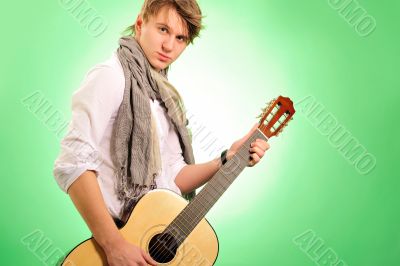 Closeup portrait of cute caucasian man playing the guitar over g