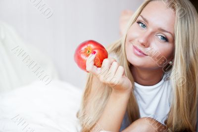 Closeup portrait of young pretty woman lying in her bed at morni