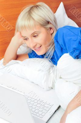 beautiful young blond woman on the bed at home