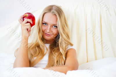 Closeup portrait of young pretty woman lying in her bed at morni