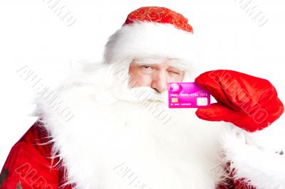 Traditional Santa Claus holding and sowing credit card while giv