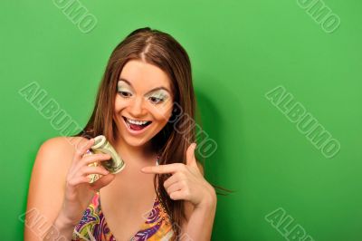 Portrait of a happy woman with a fan of American dollar 