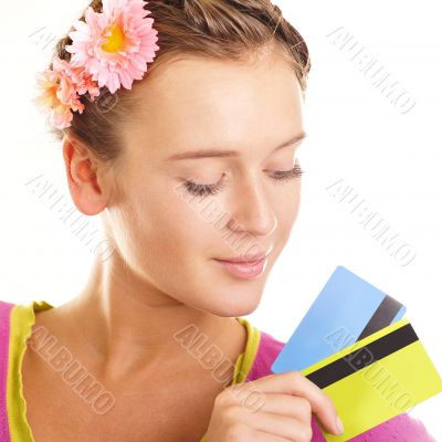 Beautiful young woman looks down at colorful credit cards in her