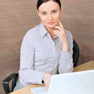 Portrait of a beautiful young businesswoman on the computer, lis