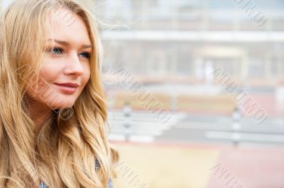 Closeup portrait of a beautiful woman in the city at summer time
