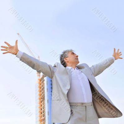 Portrait of a businessman with arms open.