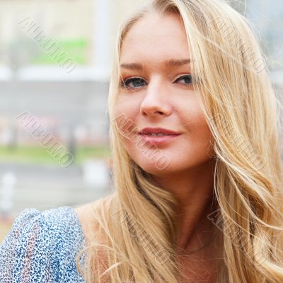 Closeup portrait of a beautiful woman in the city at summer time