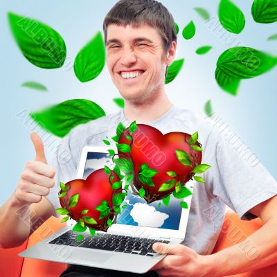 Portrait of young man thumbs up and showing display of his lapto