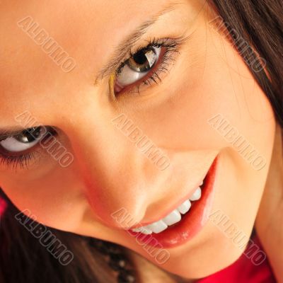 Portrait of pretty young woman on pink background with flower in