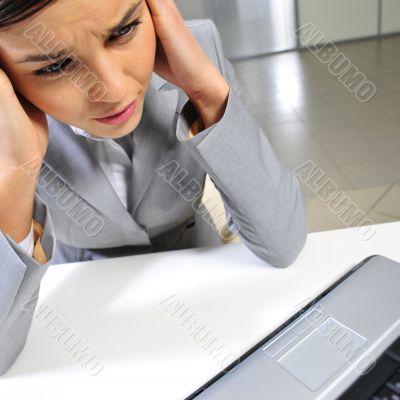 Young business woman on a laptop at her office