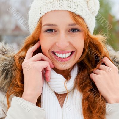 Portrait of beautiful young red hair woman outdoors in winter lo