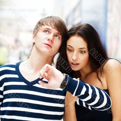 Portrait of young couple standing together at airport hall and l
