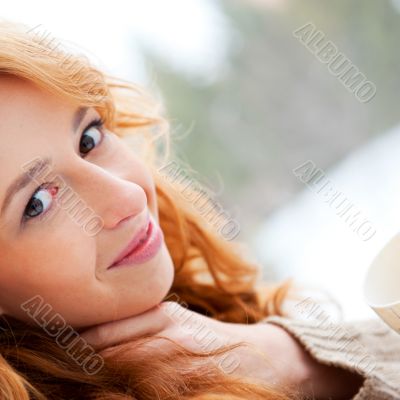 Portrait of beautiful red hair girl relaxing and looking at came