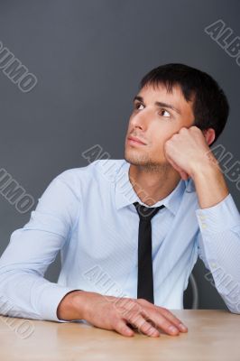 Portrait of an adult business man sitting in the office and dayd