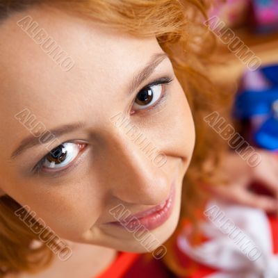 Christmas woman near a Christmas tree holding big gift box while