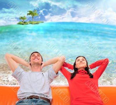 Closeup portrait of adult couple sitting on their sofa at sunny 