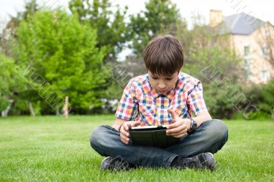 Young boy outdoors on the grass at backyard