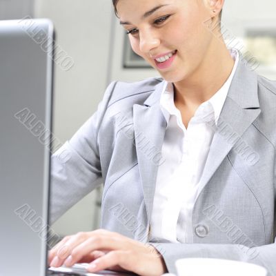 Young business woman on a laptop at her office. Working