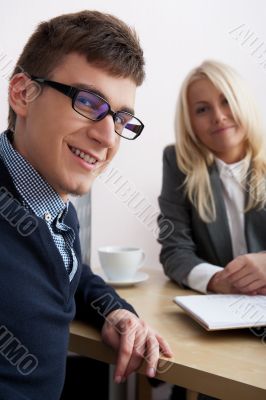 Young successful smiling business people are working in the offi