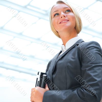 Portrait of a cute business woman with her laptop inside office 