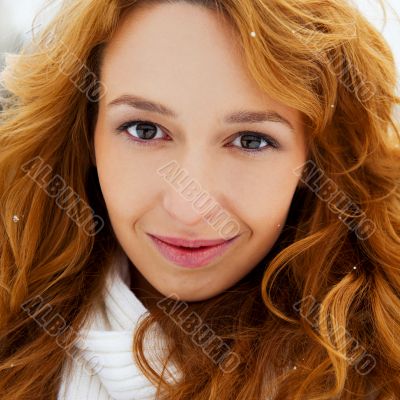 Portrait of young pretty woman in winter park