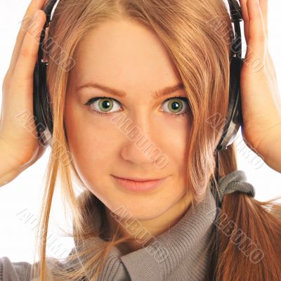 Young woman wearing headphones listening to the language course