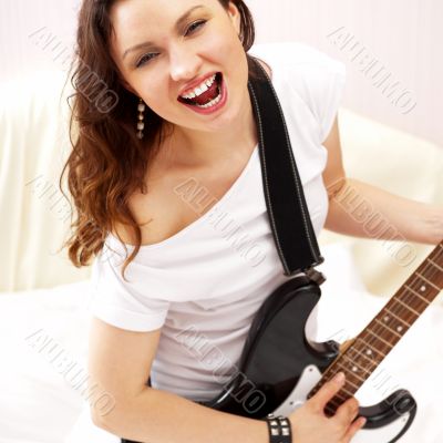 Portrait of young pretty girl who is feeling free and playing gu