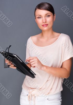 Portrait of young pretty woman holding tablet computer and glass