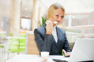 Portrait of a pretty businesswoman sitting at cafe with a laptop