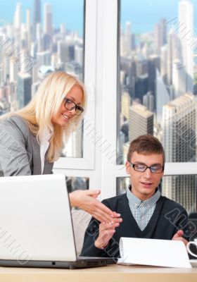 Young and successful smiling business people are working in the 