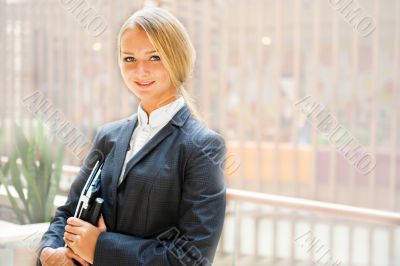Portrait of a cute business woman with her laptop inside office 