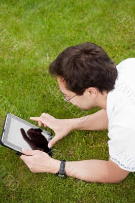 Man lying in the park at his backyard