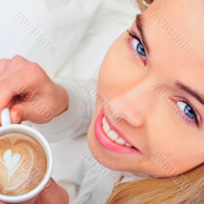 Portrait of young woman laying in bed