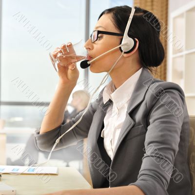 Portrait of a beautiful young businesswoman drinking water.