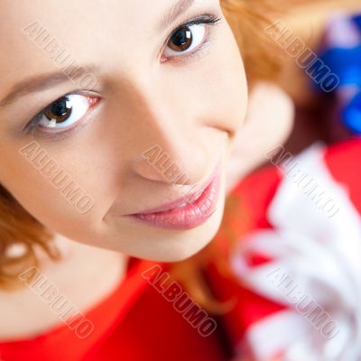 Christmas woman near a Christmas tree holding big gift box while