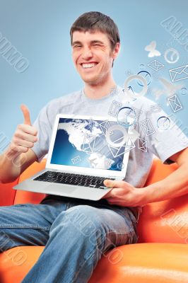 Closeup of a young smiling business man sitting at his home offi