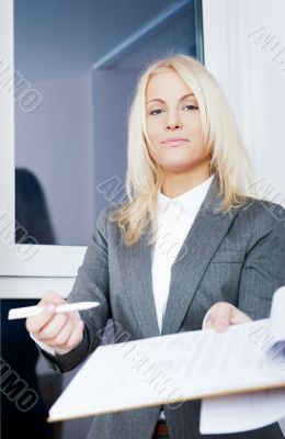 Portrait of young business woman wearing formal clothes giving c