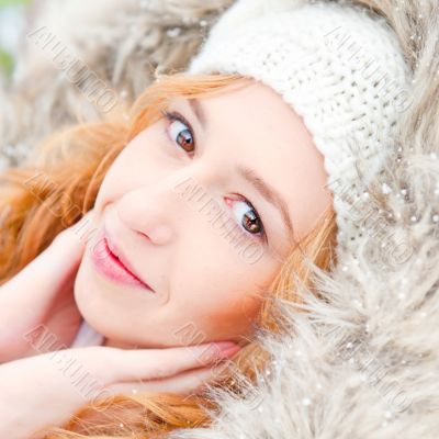 Portrait of pretty girl at winter background wearing warm clothe