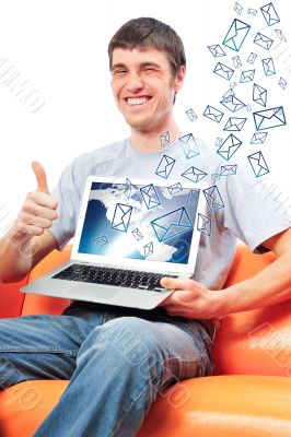 Portrait of handsome young man holding laptop computer and worki