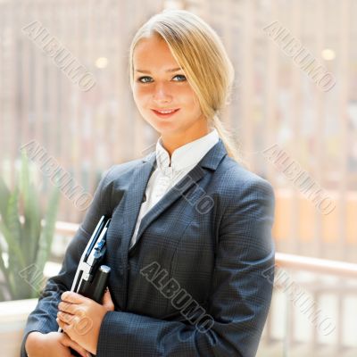 Portrait of a cute business woman with her laptop inside office 