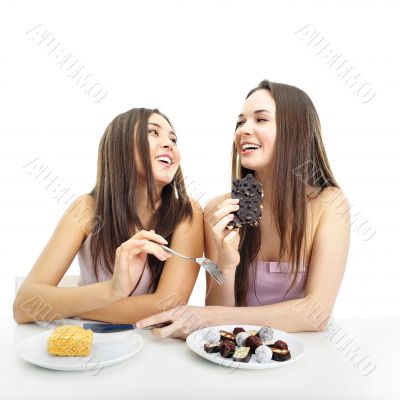 Two women whispering and smiling