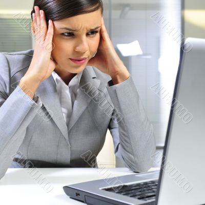 Young business woman on a laptop at her office