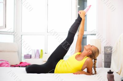 Portrait of beautiful young woman doing exercise at her home