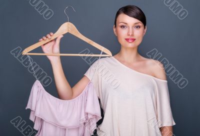 Portrait of pretty fashionable woman trying new clothes. Fashion