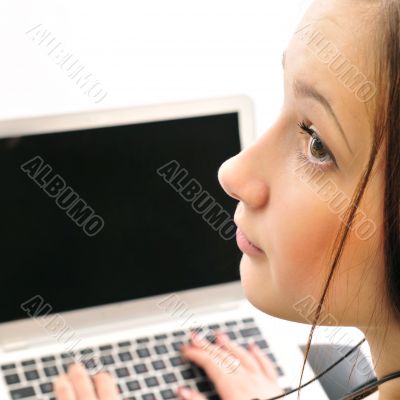 Young business woman on a laptop from behind