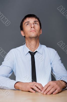 Portrait of an adult business man sitting in the office and dayd