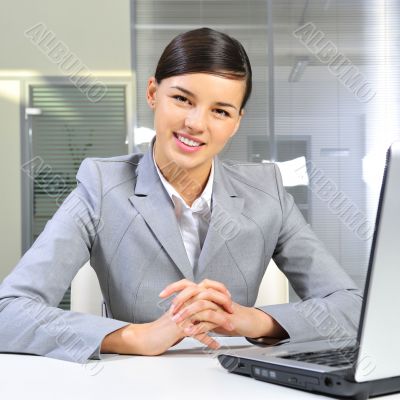 Young business woman on a laptop at her office