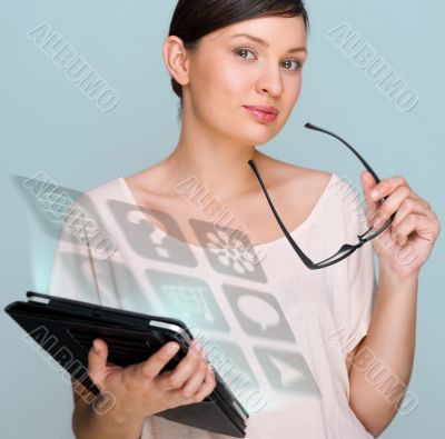 Portrait of young pretty woman holding tablet computer and glass