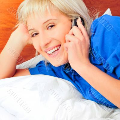 beautiful young blond woman on the bed at home