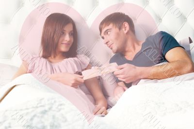 Closeup portrait of a happy young couple relaxing on the bed. Ma